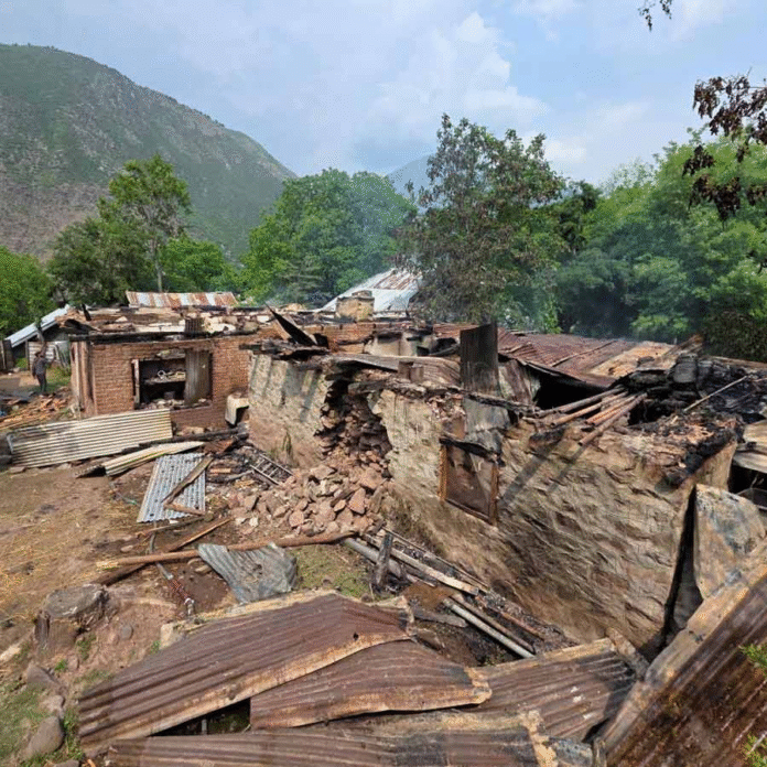 পাক গোলার বিধ্বস্ত গ্রাম। ছবি: রয়টার্স।